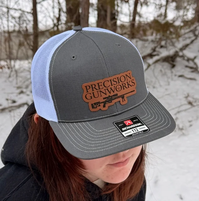Gray and white hat with a leather brown patch