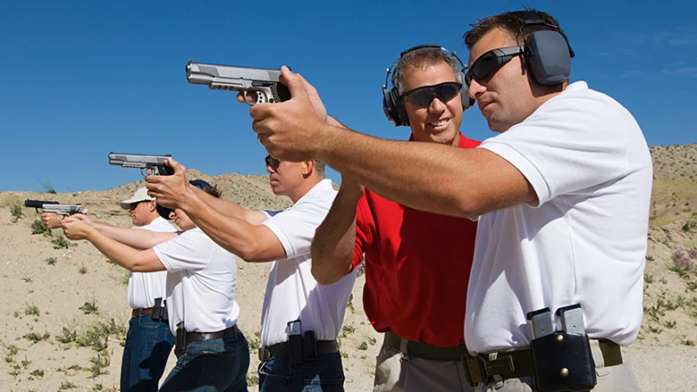 Pistol class, firearms training, instructor talking with student